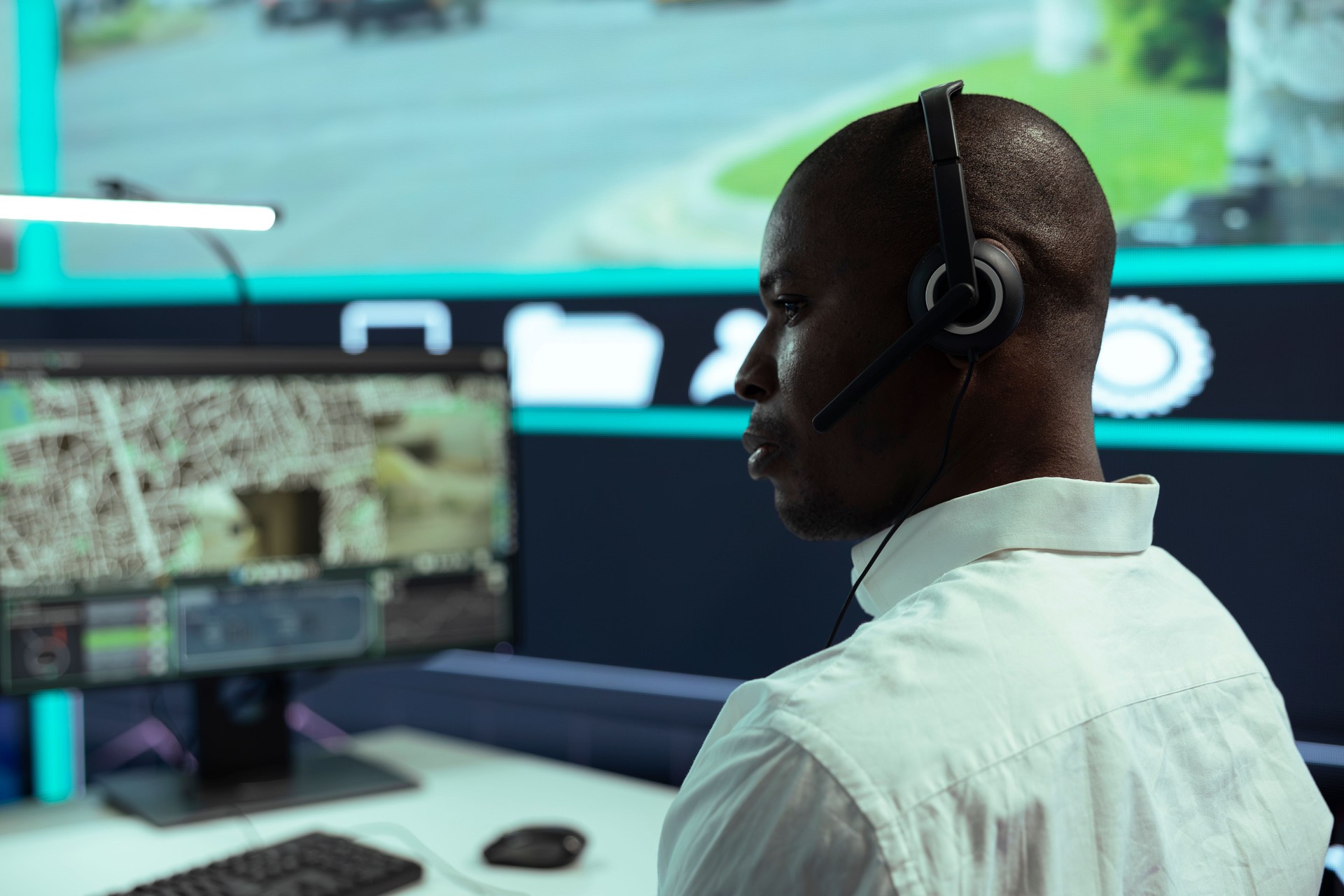 African american guy supervising traffic activity via CCTV system