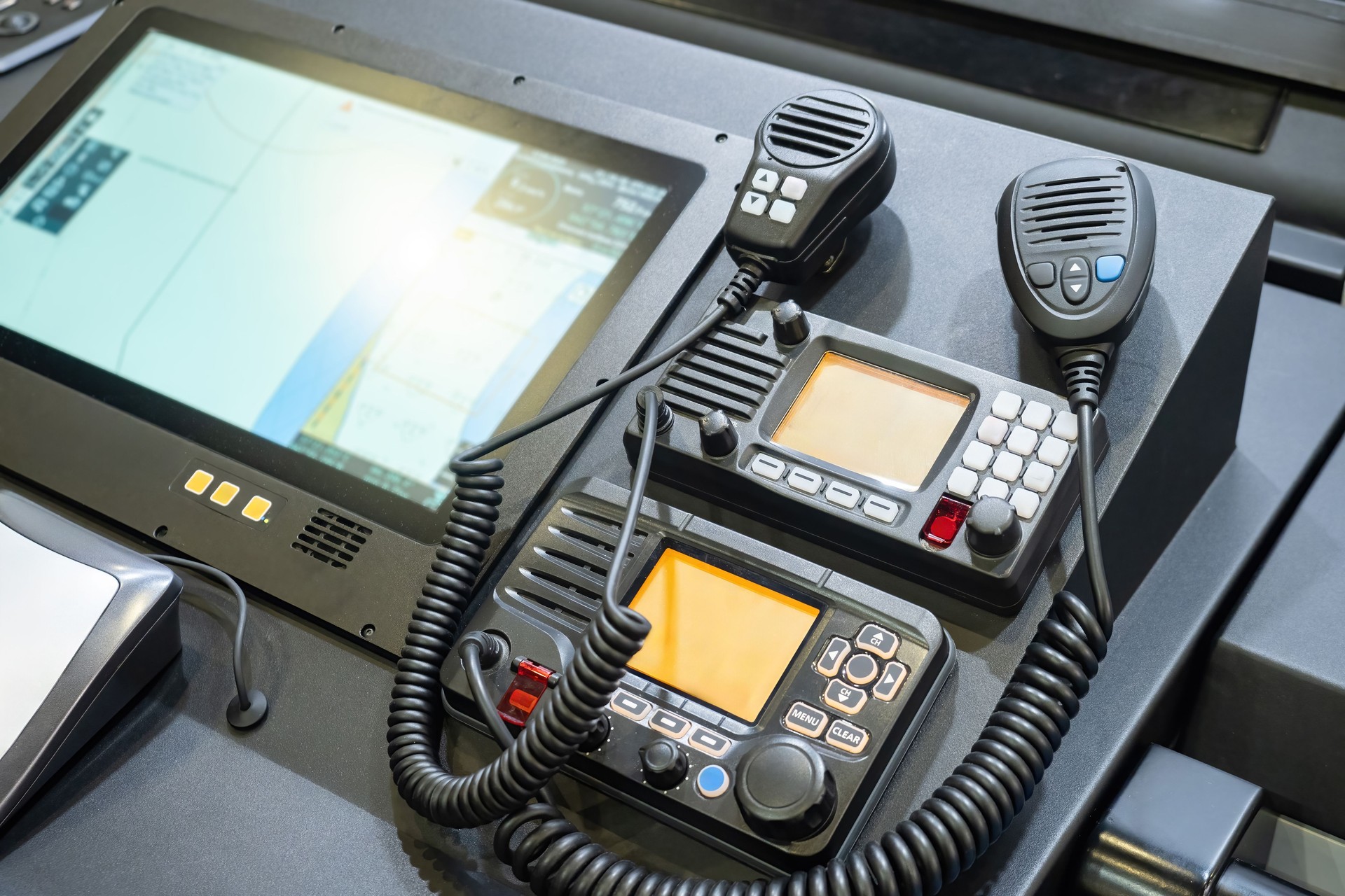 Walkie-talkies on dashboard of boat. Equipment for negotiations on captain bridge. Stationary radios on yacht. Technical equipment of modern boat. Walkie-talkies for sending SOS signal.